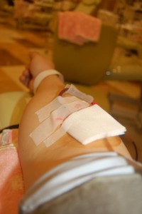 成分献血の採血針が入った右腕